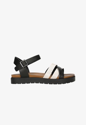 Black and white women's sandals featuring leather straps, textured white upper, adjustable ankle strap, and a durable platform sole.