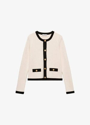 Cropped cardigan in cream with black trim, featuring golden buttons and two front pockets. Made from a soft fabric, it has a round neckline.
