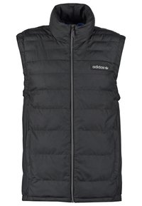 Svart ärmlös pufferväst med hög krage, framdragkedja och subtilt varumärkesmärke. Horisontellt quiltad struktur genomgående.