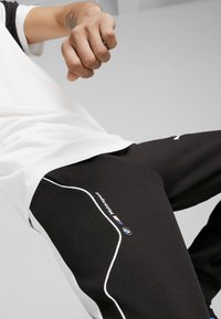 Puma Treniņtērpa apakšdaļas - black