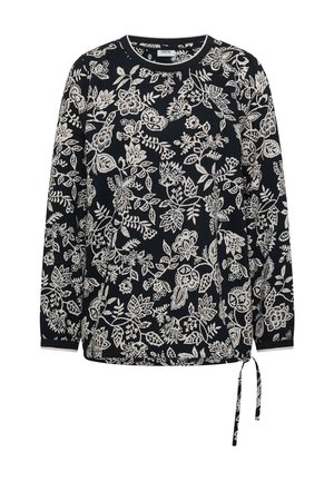 Haut noir à manches longues avec motif floral et feuilles blanches, encolure ronde, et lien latéral ajustable à l'ourlet.
