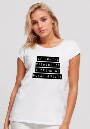 White short-sleeve t-shirt featuring bold black text: "IF LOVING FASHION IS A CRIME WE PLEAD GUILTY." Soft, smooth fabric.