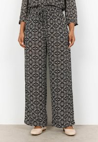 Svarta vida byxor med ett neutralt blommigt geometriskt mönster, elastisk midja och lätt, texturerad tyg.