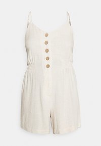 Combinaison sans manches en lin beige avec de fines bretelles, cinq boutons en bois sur le devant, taille élastiquée et shorts amples.