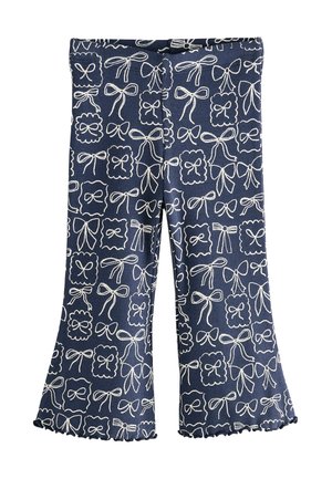 Marina blå vadande leggings med ribbad textur, utsmyckade med ett vitt rosmönster och vågiga fållar. Elastisk midja för komfort.
