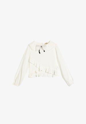 Hvid langærmet bluse med flæse-design, rund krave og sort slips. Glat stof med en struktureret flæse langs kanten.