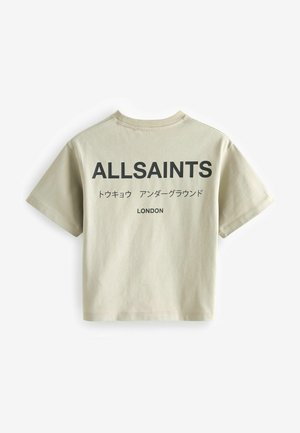 Vaaleanbeige puuvillainen t-paita, jossa on lyhyet hihat, pyöreä kaula-aukko ja suuri musta teksti "ALLSAINTS" selässä, sekä lisäteksti ja logo.