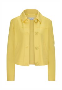 Gelbe, kurze Jacke aus glattem Stoff. Verfügt über einen klassischen Kragen, einen Knopfverschluss, zwei Vordertaschen und sichtbare Nähte.