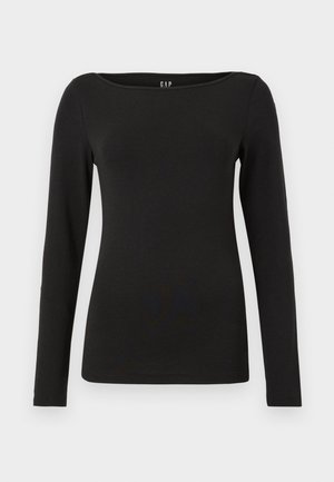 Haut noir à manches longues en coton doux. Il présente un col rond et une coupe ajustée, avec des coutures nettes et sans embellissements visibles.