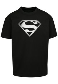 Must musta t-särk, millel on ees valge täpiline Supermani logo klaadikuju. Lühikesed varrukad ja ümar kaelus.