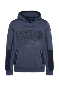 Navy blue hoodie featuring a kangaroo pocket, zippered side pockets, and printed text with a compass design on the front. Cotton blend material.
