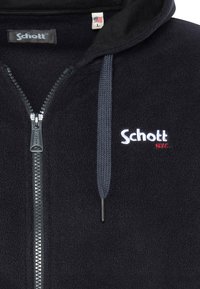 Felpa nera con zip e cappuccio, con "Schott N.Y.C." ricamato sul petto, chiusura con zipper e lacci blu sul cappuccio.