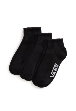 Tres pares de calcetines tobilleros negros con puños de canalé, un par con el logo blanco de Vans en el lateral.