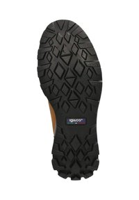 Suela de zapato de goma negra con un diseño de textura y tracción que presenta patrones de diamante y trapecio. La etiqueta de la marca cerca del talón dice "IGI&CO Hecho en Italia."