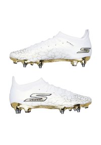 Vita fotbollsskor med ett sprucket guldmönster, silveraccenter, en lätt överdel och en låg profil. Har formar för bättre fäste.