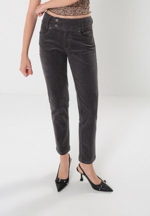 Gray corduroy pants with a slim fit, front pockets, and two-button closure, paired with black pointed-toe heels.