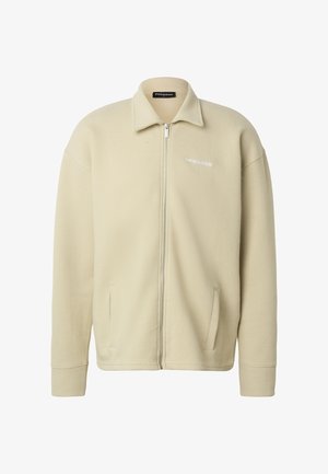 Beige full-zip knitted jacket with collar, long sleeves, side pockets, and small white brand logo on left chest.