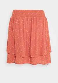 Jupe rouge à volants avec des pois blancs, dotée d'une taille smockée et d'un design légèrement évasé. Fabriquée en tissu léger.
