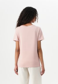 Pink short-sleeve T-shirt made of soft fabric, featuring a standard crew neck and relaxed fit. No notable patterns or accents visible.