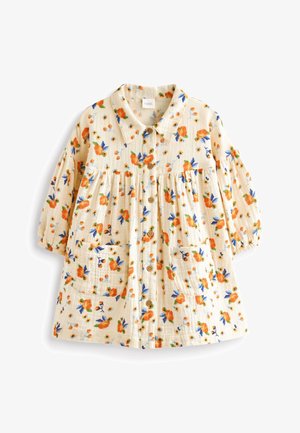 Robe bébé couleur crème avec imprimé floral orange et bleu, manches longues bouffantes, boutons à l'avant, deux poches avant et un col.
