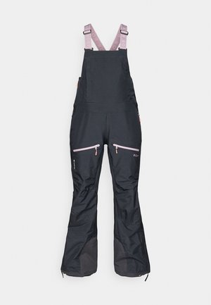 Sorte vandtætte overalls med justerbare rosa stropper, der har lynlåslommer og forstærkede nederste sektioner for holdbarhed.