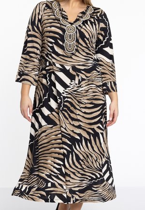 Abito lungo e ampio con motivo a strisce di tigre in nero, beige e bianco. Scollo a V decorato con perline ornamentali.