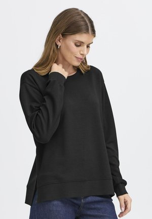 Zwarte sweatshirt met lange mouwen, ronde hals en zijsplitten. Zachte stof met een gladde textuur en een ontspannen pasvorm. Geschikt voor casual dragen.
