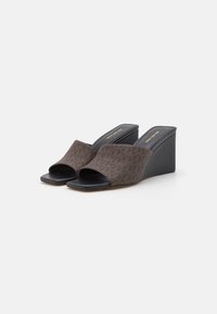 Sandales compensées avec un dessus brun à motifs, une conception à bout ouvert et un talon compensé noir élégant. Semelle extérieure noire lisse avec des accents minimalistes.