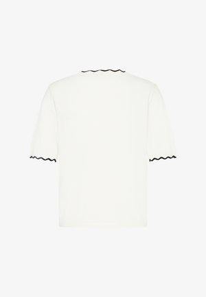 Valkoinen lyhythihainen paita, jossa mustat aaltoilevat reunat hihoissa ja pääntiellä, kuvattuna takaa valkoisella taustalla.