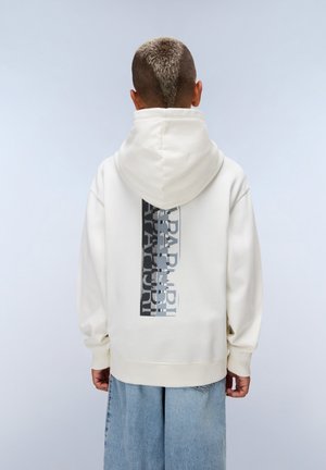 Crème hoodie met een grafische print in grijs en zwart op de achterkant, voorzien van een capuchon met trekkoord en geribde manchetten. Gekocht met lichtblauwe wijde jeans.