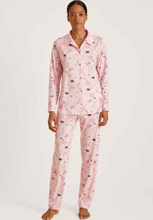 Pink pajama set featuring long sleeves and pants, with a playful pattern of dogs in various colors, made from soft fabric with a smooth texture.