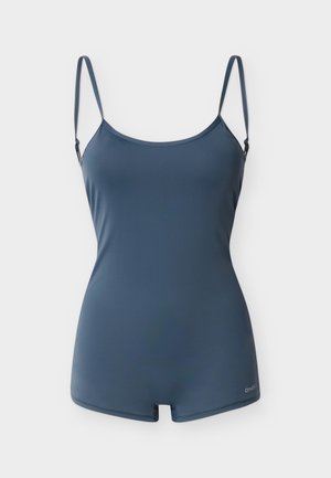 Maillot de bain une pièce bleu foncé avec fines bretelles réglables et couverture courte des jambes sur fond blanc.