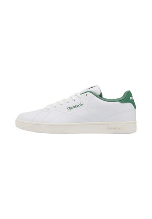 Zapatilla Reebok blanca de corte bajo con forro interior verde, talón verde y logotipo en el costado y la suela, mostrada de perfil sobre fondo blanco.
