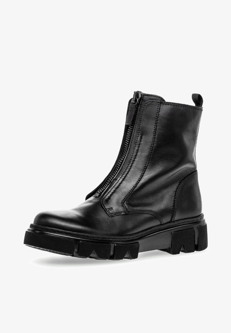 Schwarze Leder-Stiefelette mit seitlichem Reißverschluss, klobiger Gummisohle und ausgeprägten Grip-Mustern. Verfügt über eine glatte Oberfläche und verstärkte Nahtdetails.