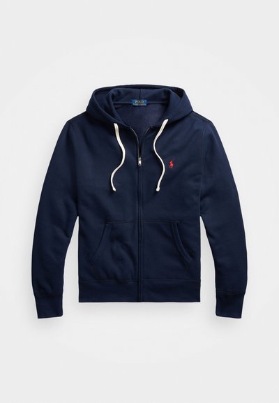 Sweatshirt com fecho éclair na cor azul-marinho, com cordões brancos, bolsos frontais e um pequeno logotipo vermelho da Polo Ralph Lauren no peito.