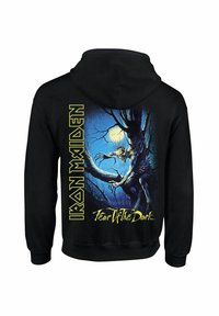 Black hoodie featuring "Iron Maiden" in bold yellow text. Back design shows a detailed, colorful illustration of a creature in a dark forest.