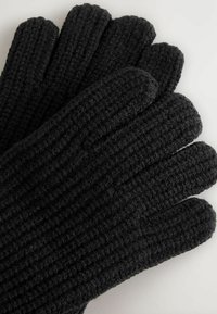 Guanti neri lavorati a maglia con texture a coste, progettati con cinque dita, realizzati in materiale morbido e peloso.