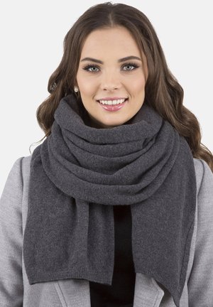 Dark gray scarf made of soft material, featuring multiple layered folds and a wide design, draped over a light gray coat.
