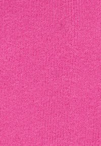 Knitted fabric in a vibrant pink color with a smooth texture and fine vertical ribbing pattern throughout.