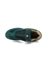 Grüne Wildleder-Laufschuhe mit strukturiertem Obermaterial, runder Zehenpartie, schwarzen Schnürsenkeln und beigem Innenfutter. Mit Logo auf der Zunge und Gummisohle.