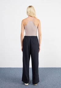 Nike Sportswear STRAIGHT PANT - Tracksuit bottoms - black
