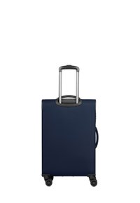 Valigia rigida blu navy con finitura testurizzata, quattro ruote, manico telescopico e una maniglia laterale.