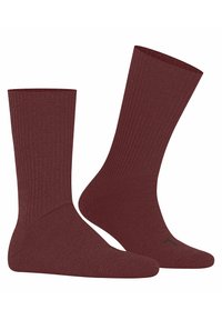 Chaussettes côtelées bordeaux de longueur moyenne. Texture douce et bord élastique pour le confort. Détail subtil du logo noir sur le côté.