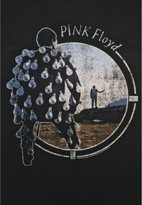 Černé tričko s grafickým designem postavy, která má na zádech žárovky, obklopené bílým obrysem, s nápisem "PINK Floyd" nahoře.