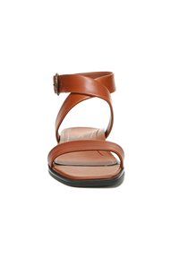 Brown leather sandal with cross-strap design, flat sole, and a buckle detail. Smooth texture with a simple and minimalistic shape.