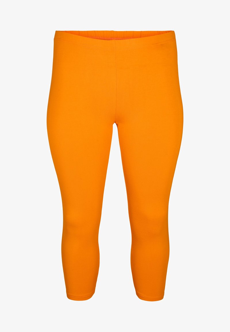 Oranssi legginsit, jotka on valmistettu joustavasta materiaalista, joissa on tiukka muotoilu ja joustovyötärö. Sileä pinta ilman näkyviä kuvioita tai yksityiskohtia.