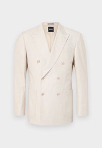 Beige double-breasted blazer made from textured fabric. Features two patch pockets and a notched lapel. Brand label visible inside collar.
