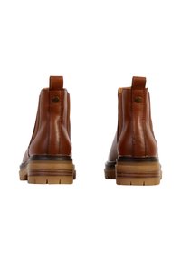 Brown leather ankle boots with elastic side panels, rounded toe, and chunky beige rubber sole. Features a back pull tab and decorative stitching.