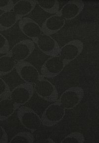 Textured black fabric featuring a subtle pattern of intertwined circular shapes, providing a smooth, matte finish with a cohesive design.