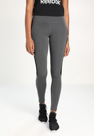 Leggings de sport gris en matériau extensible, avec un design ajusté, des panneaux d'accent noirs sur les côtés et une taille haute.